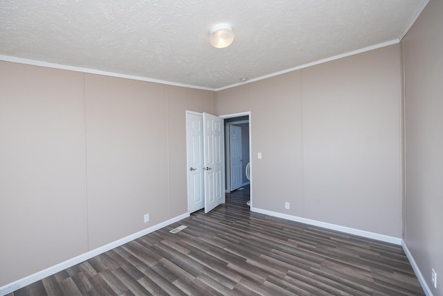 empty room featuring crown molding, dark hardwood / wood-style flooring, and a textured ceiling