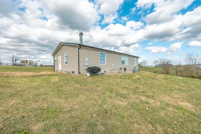 rear view of property with a lawn