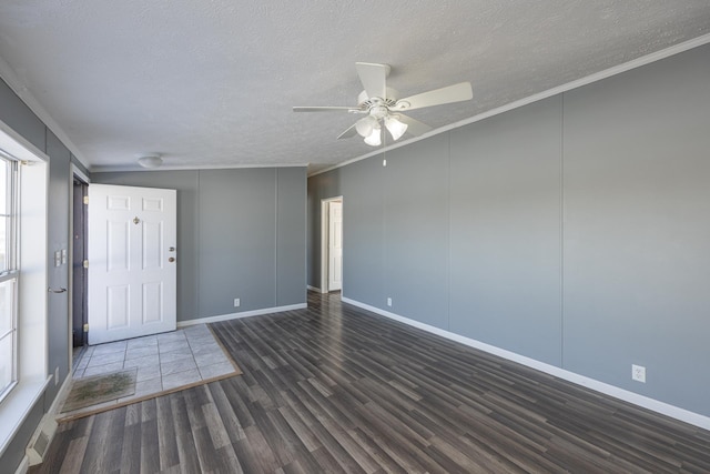 spare room with dark wood-type flooring, ceiling fan, ornamental molding, and a textured ceiling