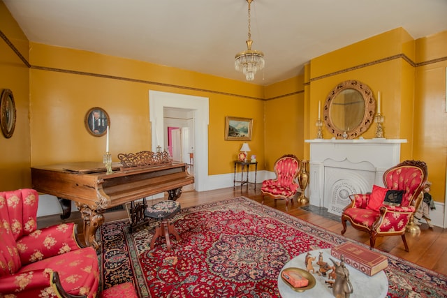 sitting room featuring an inviting chandelier and wood-type flooring