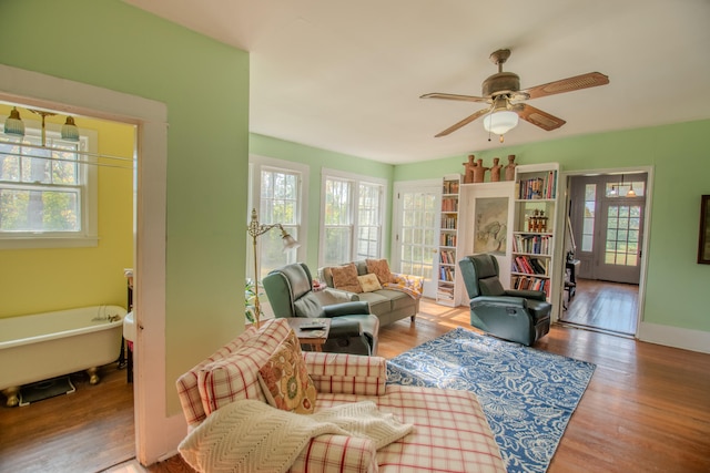 living room featuring a wealth of natural light, hardwood / wood-style flooring, and ceiling fan