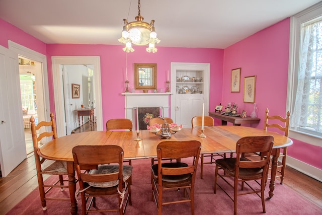 dining area featuring a notable chandelier and wood-type flooring