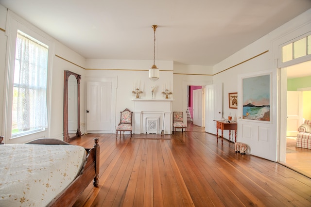 bedroom with wood-type flooring and multiple windows