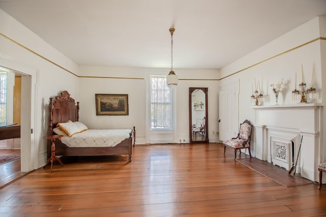 bedroom with dark wood-type flooring