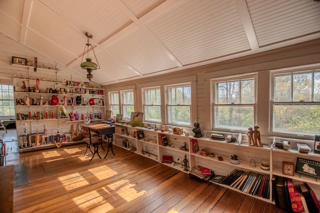 interior space featuring a wealth of natural light, hardwood / wood-style floors, and wooden walls