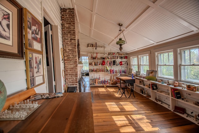 interior space with hardwood / wood-style flooring, wooden ceiling, vaulted ceiling, and brick wall