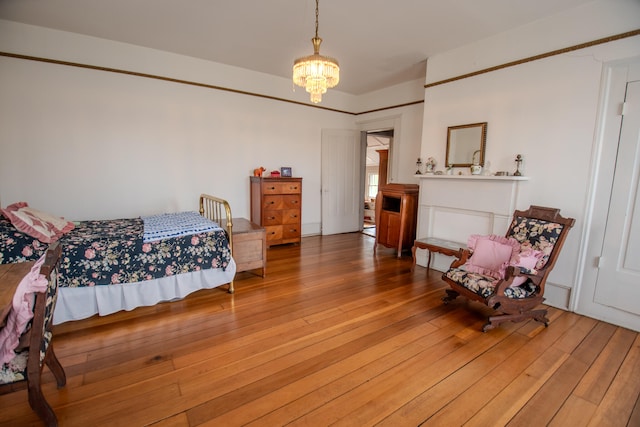 bedroom with a chandelier and wood-type flooring