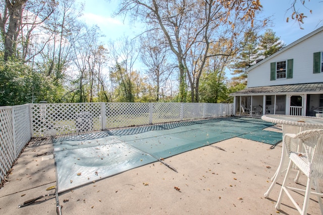 view of pool with a patio and a sunroom