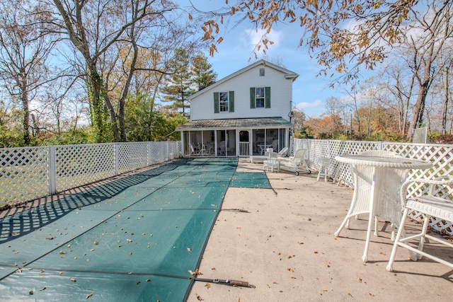 view of pool featuring a patio and a sunroom