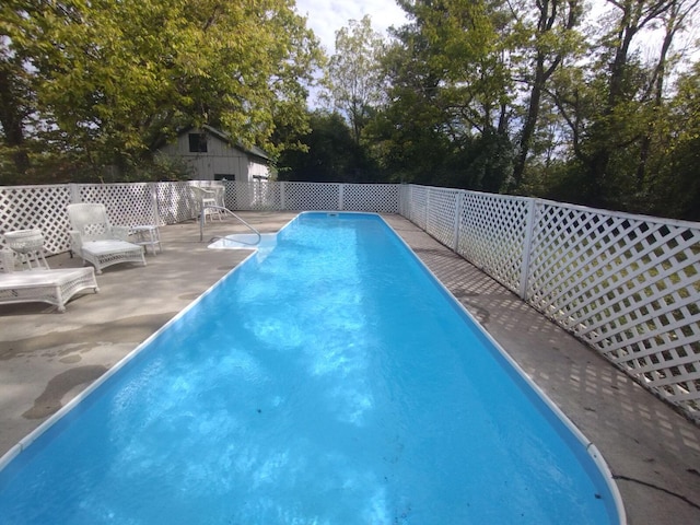 view of swimming pool featuring a patio area