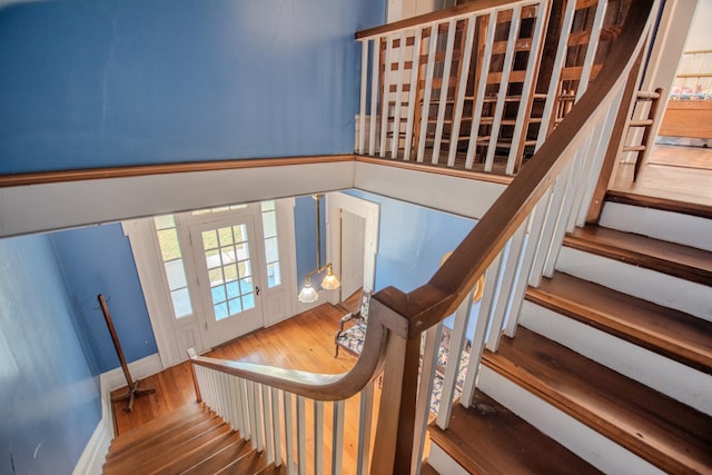 stairway with hardwood / wood-style floors