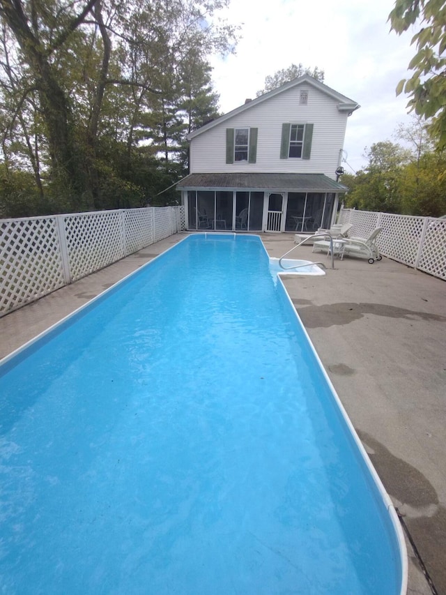 view of pool with a sunroom