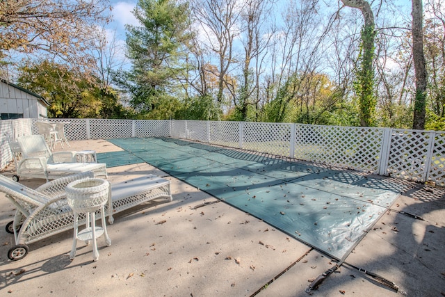 view of swimming pool featuring a patio area