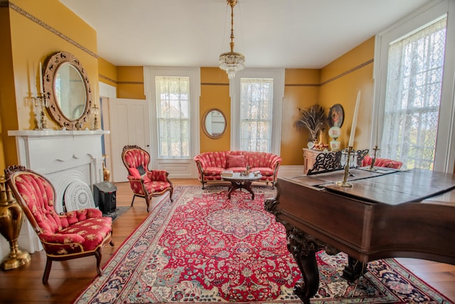 sitting room with hardwood / wood-style flooring and a chandelier