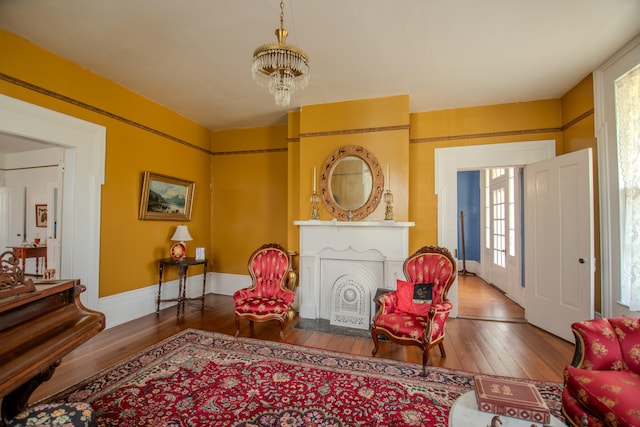 living area with a notable chandelier and hardwood / wood-style floors