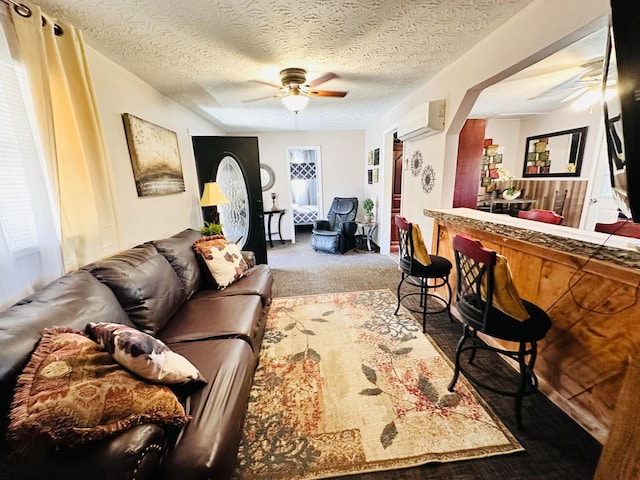 carpeted living room featuring a textured ceiling, a wall mounted air conditioner, bar area, and ceiling fan