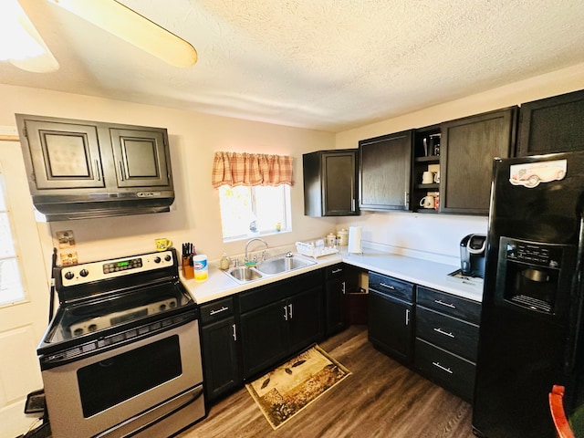 kitchen with dark hardwood / wood-style floors, black fridge, sink, electric range, and a textured ceiling