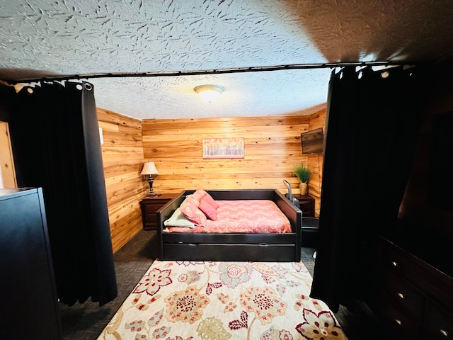 carpeted bedroom featuring wood walls