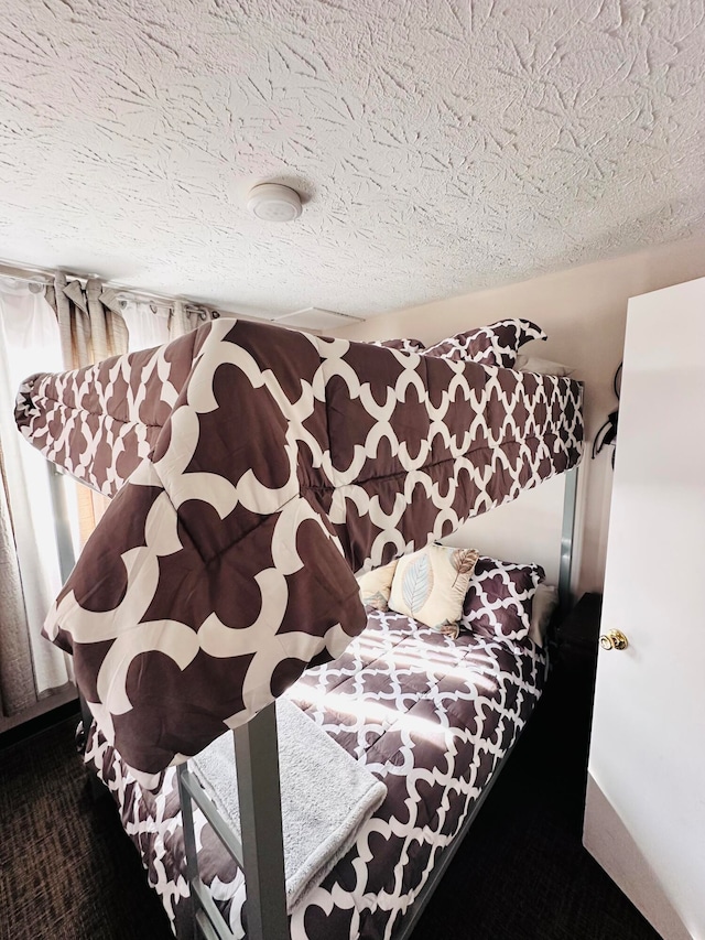 bedroom featuring carpet and a textured ceiling