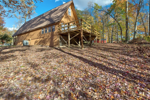 rear view of property featuring a deck