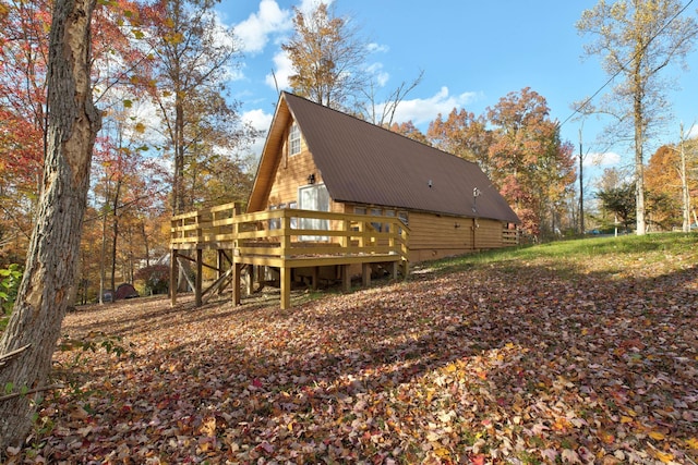 back of house with a deck