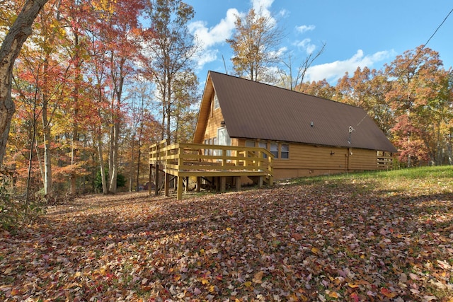 rear view of house featuring a deck