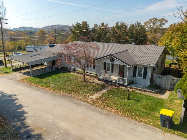 view of front of house featuring covered porch and a front lawn