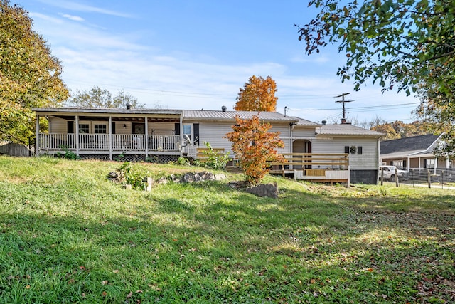 back of house with a yard and a wooden deck