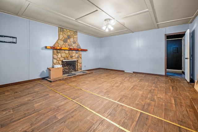 unfurnished living room with hardwood / wood-style floors and a fireplace