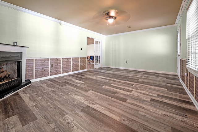 unfurnished living room featuring ornamental molding, dark wood-type flooring, and ceiling fan