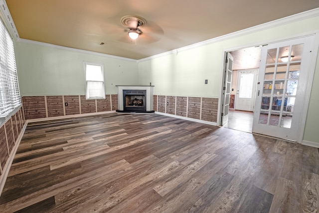 unfurnished living room with crown molding, brick wall, dark hardwood / wood-style flooring, and ceiling fan