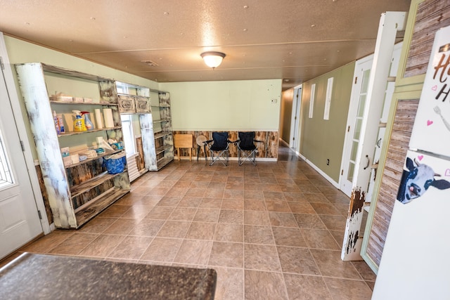 interior space with white fridge and a textured ceiling