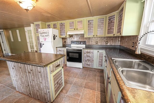 kitchen featuring sink, a kitchen island, a textured ceiling, and white appliances