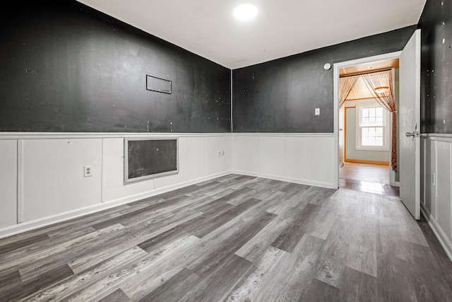 unfurnished room with hardwood / wood-style floors