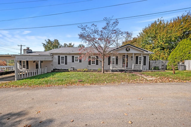 ranch-style home with a front yard and covered porch