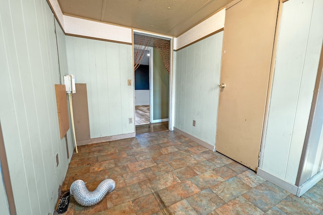 unfurnished bedroom featuring wooden walls