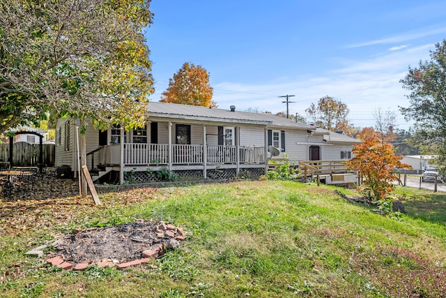 rear view of house with a yard and a deck