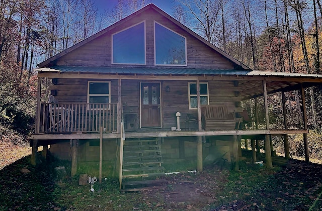 rear view of property featuring a porch