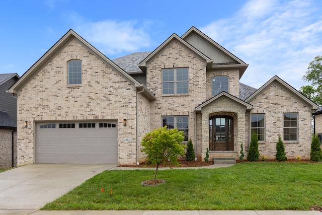 view of front of property with a front lawn and a garage