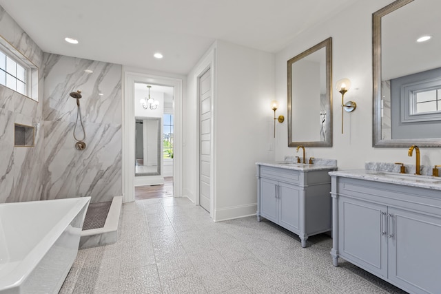 bathroom featuring vanity, an inviting chandelier, and plus walk in shower