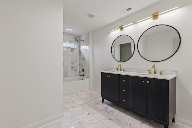 bathroom with vanity and tiled shower / bath combo