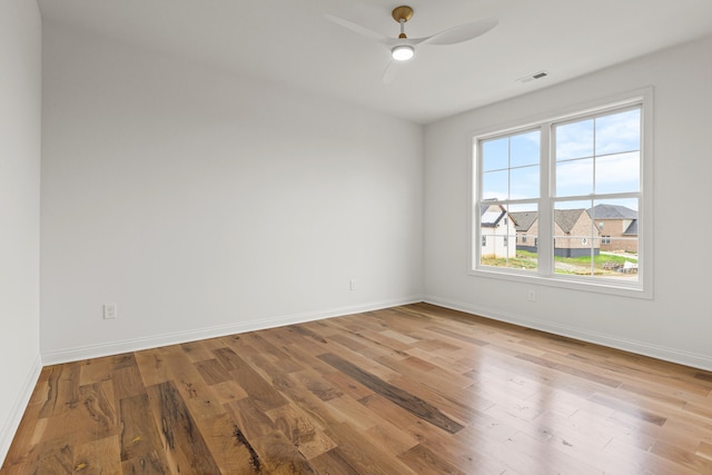 empty room featuring ceiling fan and hardwood / wood-style floors