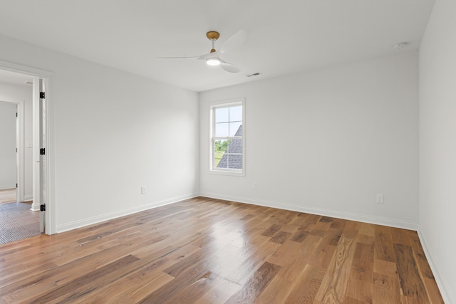 empty room featuring light wood-type flooring and ceiling fan