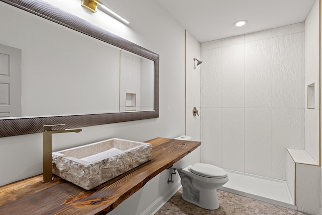 bathroom with toilet, vanity, and a shower