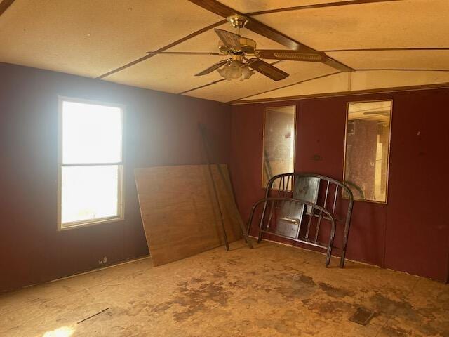 interior space with ceiling fan and vaulted ceiling