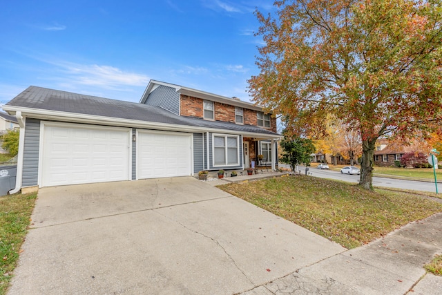 view of front of property with a garage and a front lawn