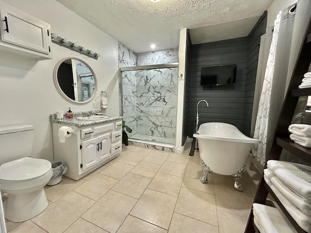 full bathroom featuring plus walk in shower, toilet, tile patterned flooring, vanity, and a textured ceiling