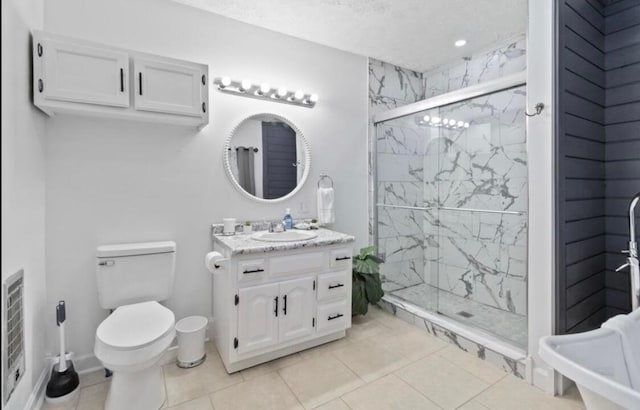 bathroom featuring toilet, an enclosed shower, vanity, and tile patterned floors