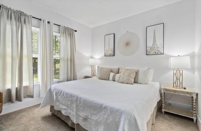 bedroom featuring light carpet