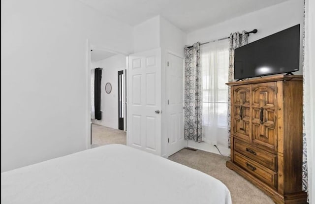 bedroom with light colored carpet